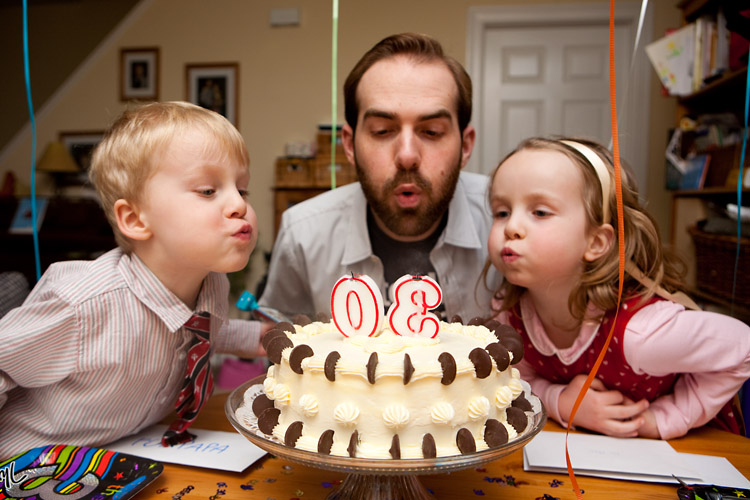 Helping Papa take care of the candles (and later the cake)