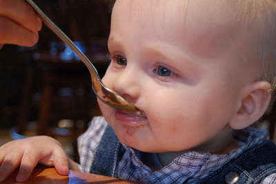Having his first taste of an ice cream sundae