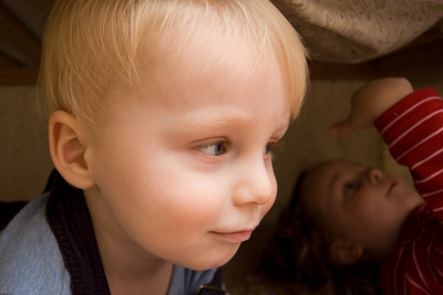 Sliding under the crib to have a look at things