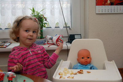 Feeding her new daughter Lara some striezel, explaining important things