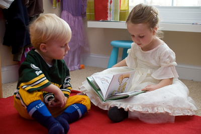 Celebrating Thanksgiving the traditional way, dressed as a football player and princess and reading stories to each other