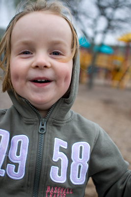 Holding on for dear life on a spinning swing at the park